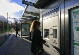 Una joven recarga la tarjeta BAT en una máquina del tranvía de Vitoria.