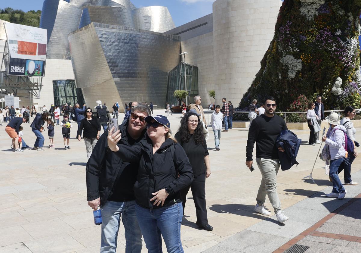 Turistas y visitantes del museo se arremolinan en torno a Puppy.