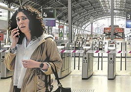Una mujer llama por teléfono, en una estación de Abando totalmente vacía, sin trenes de corto, medio ni largo radio.