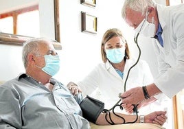 Profesionales sanitarios atienden a una persona mayor en una residencia.