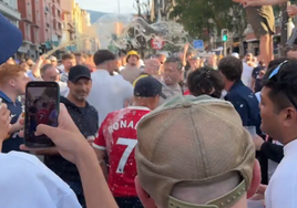 Dos aficionados del United con la camiseta de Ronaldo, empapados en cerveza por sus rivales