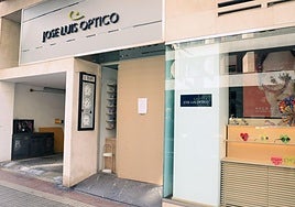 El comercio ha tenido que colocar una tabla después de que les hayan roto otra vez los cristales.