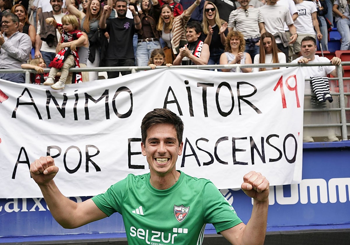 Aitor Seguín celebra el ascenso del Arenas en Ipurua ante una pancarta para darle ánimos.