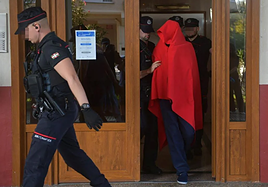 El detenido ha salido de la vivienda acompañado de varios agentes de la Ertzaintza y cubriendo su rostro con una manta roja.