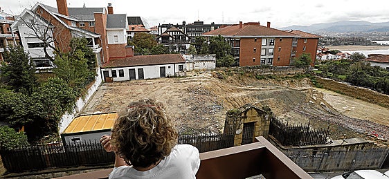 Una vecina observa el solar donde se ubicaba el palacete derribado en Algorta.