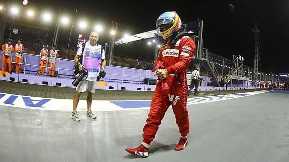 Alonso camina por la calle de garajes. 