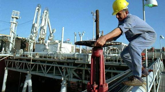 Un hombre abre la tubería de petróleo.