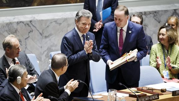 El presidente de Colombia, Juan Manuel Santos, entrega una copia del acuerdo de paz en la ONU.