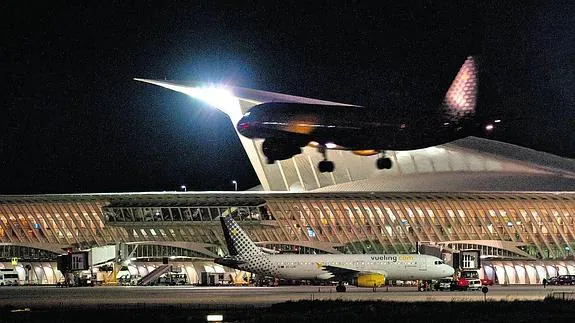 Un avión de Vueling toma tierra, ya de noche, en Loiu.