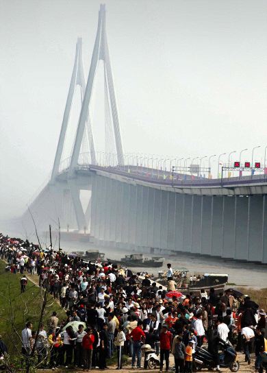 ESPECTACULAR. Cientos de chinos aguardan para asistir a la inauguración del puente. / AFP