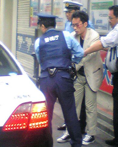 LOCURA. Varios policías retienen al agresor, después de que éste provocase el caos en Tokio. / AP