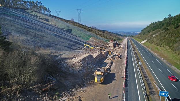 Aspecto que ofrece la zona donde se produjo el argayo, con las máquinas y operarios trabajando en la escollera y en el rebaje de la ladera.