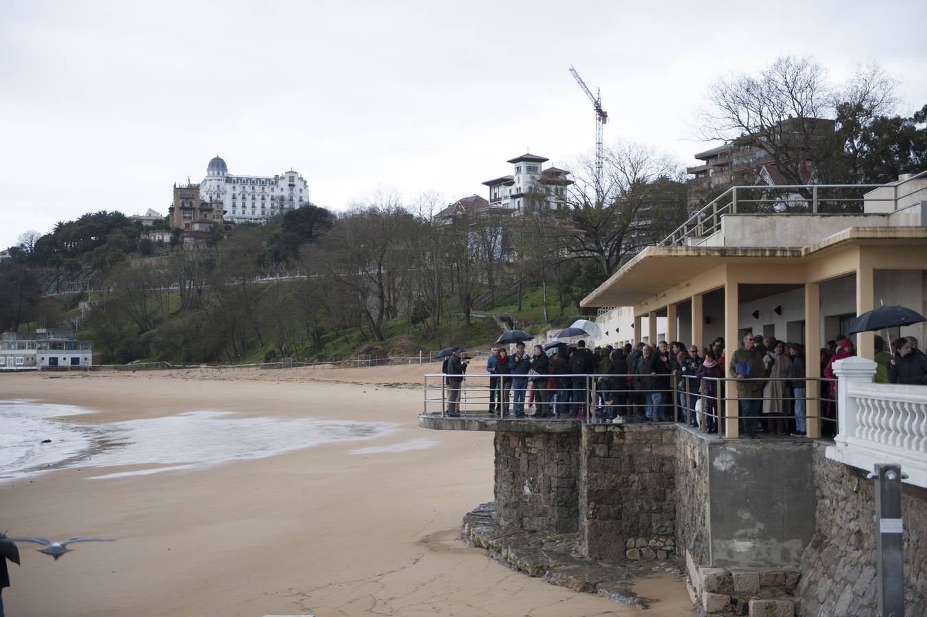 Decenas de personas se han subido este domingo a uno de los dos espigones que se están construyendo para la estabilización de la playa de la Magadalena de Santander para expresar su rechazo a la obra