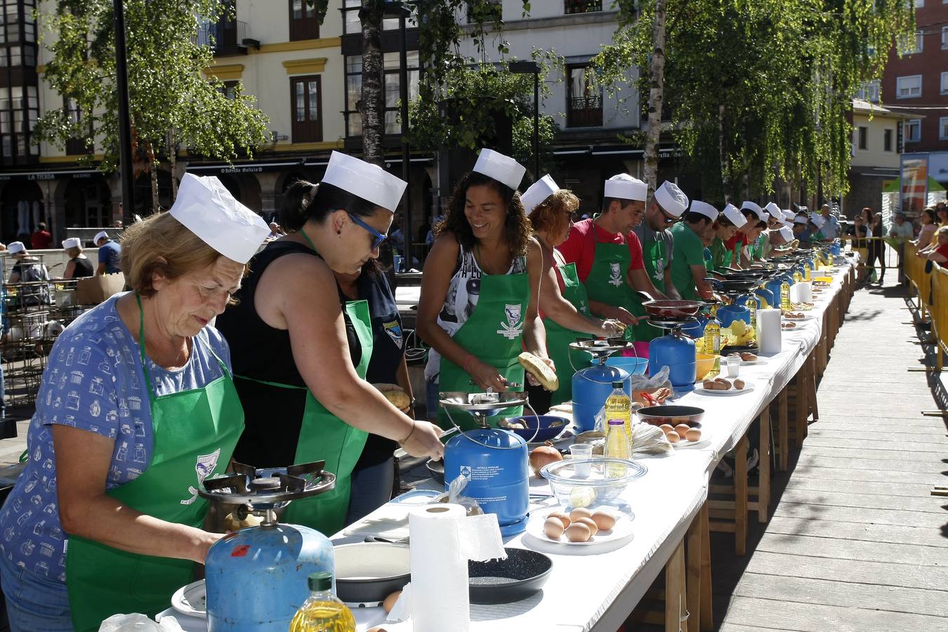 Imagen secundaria 1 - Los cocineros se prestan a elaborar sus platos de arroz o suculentas tortillas de patatas al aire libre.