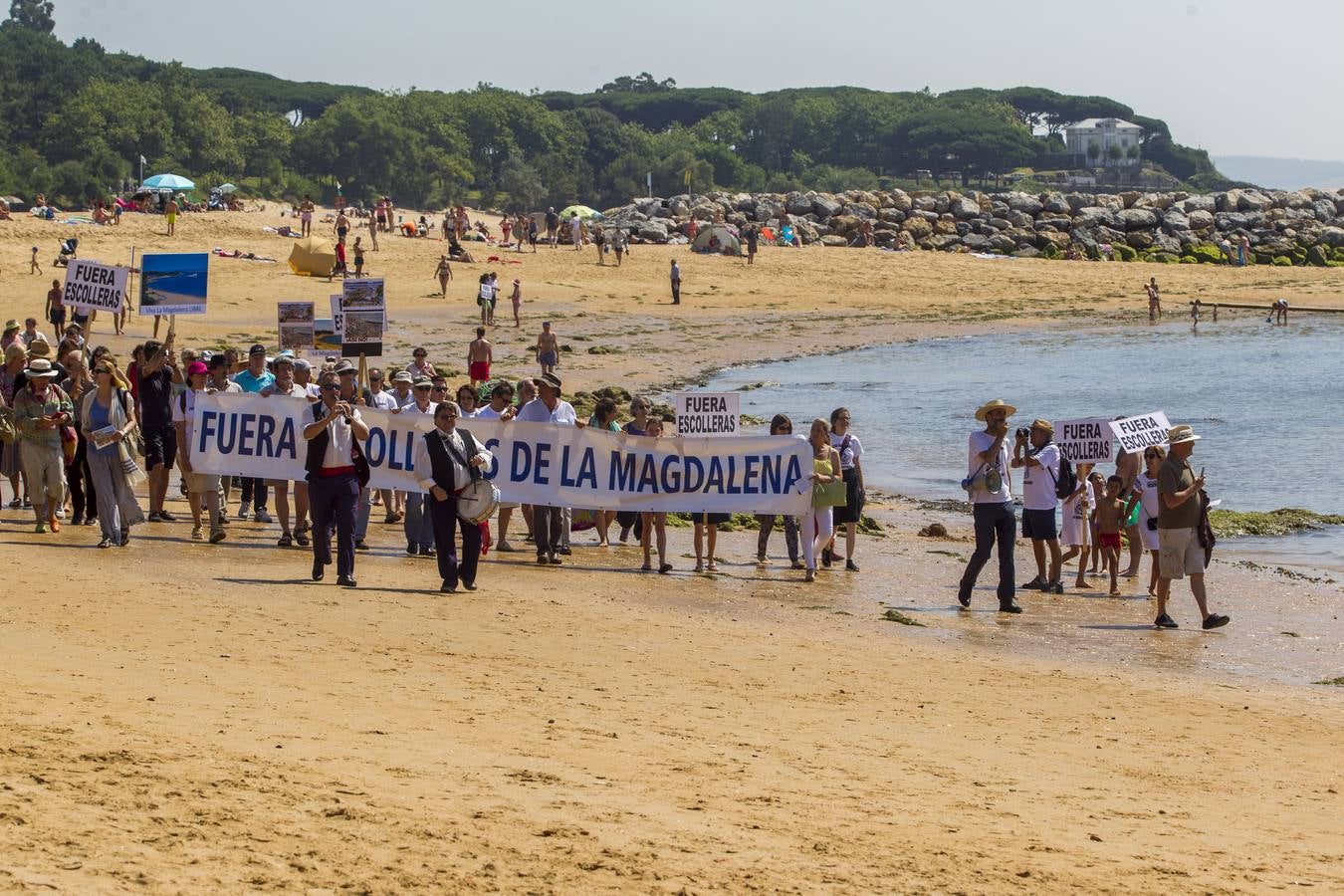 La plataforma ciudadana 'Salvar La Magdalena' ha celebrado hoy una nueva concentración para pedir la retirada de las escolleras que se están ejecutando en el arenal. El acto se ha celebrado en el Balneario de la Magdalena a las 12.30 horas y, además de la concentración en sí, ha incluido un 'pasaplayas'. Los manifestantes han aprovechado la bajamar para realizar un paseo por la orilla encabezado por un pito y tamboril con globos, pancartas y camisetas reivindicativas.