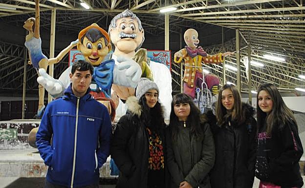 Imagen principal - Arriba, miembros de la peña Cancerberos, que participa junto a los Ramidrejus con su obra 'Cuerdos como títeres'. Abajo, últimando los detalles de las carrozas que desfilarán. 