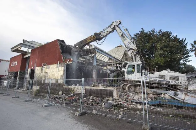 Una pala excavadora procede al derribo de una pared exterior de hormigón de la discoteca Aqua ubicada en el polígono de Raos. 