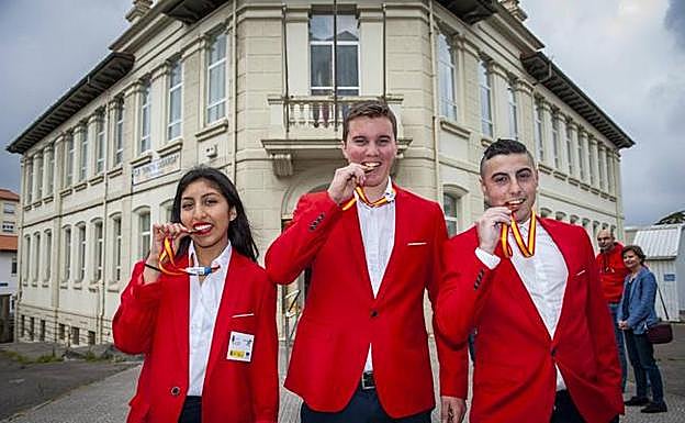 De izquierda a derecha, Ana Fiorella Rosales, Mario González Kendrik y Abel Sampedro Rosales, mordiendo sus medallas. 
