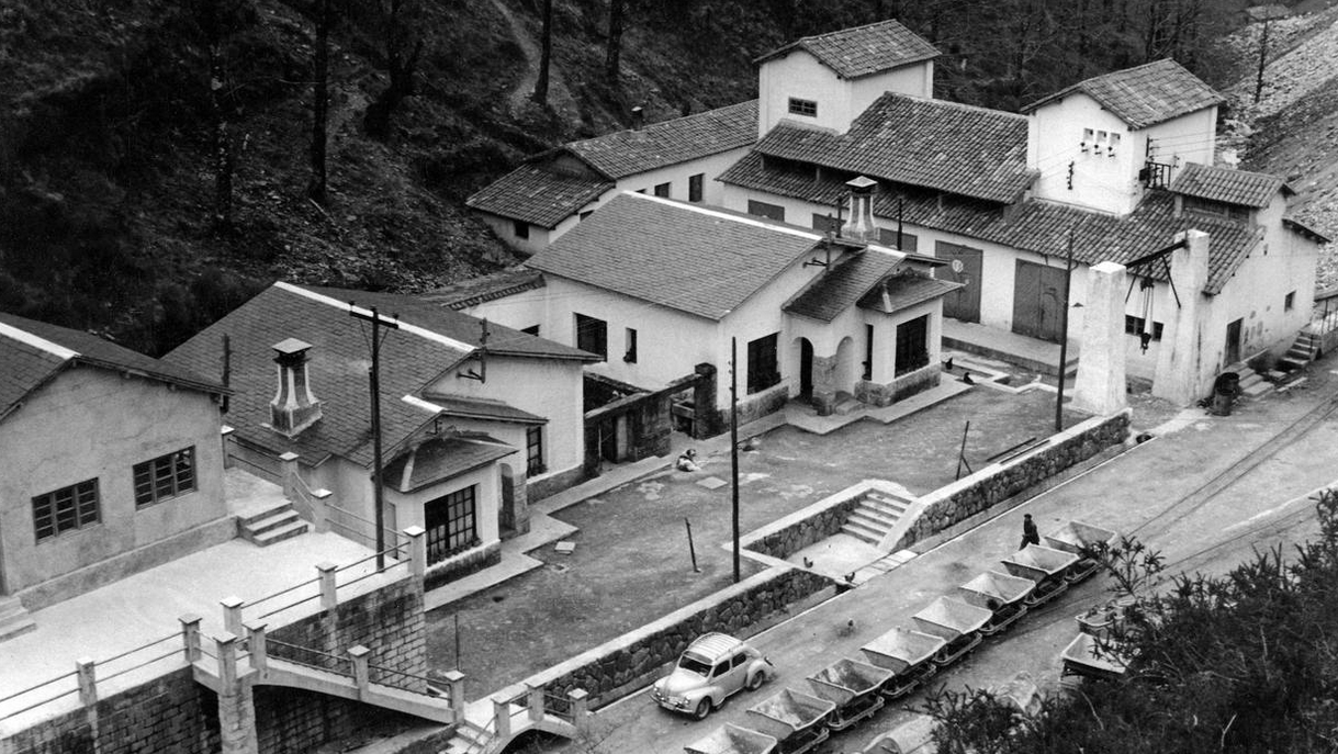 Edificaciones junto a la boca norte del túnel de la Engaña, hoy en ruina total y engullidas por la maleza. Al fondo, la central eléctrica.