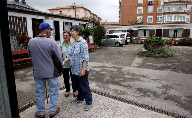 Dos de las religiosas que atienden el centro conversan con un usuario.