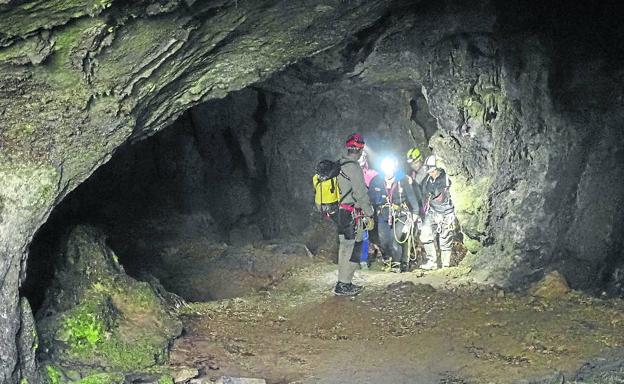 Momento en el que llegan a la salida de la cueva, sobre las 16.00 horas del lunes, las tres espeleólogas acompañadas de los rescatadores. 