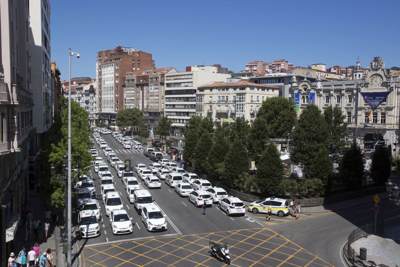 Efectivos de la Policía Local de Santander y los taxistas se han unido hoy para cortar la calle Jesús de Monasterio y paralizar el centro de la ciudad a mediodía para reclamar al Ayuntamiento que atienda sus reivindicaciones.