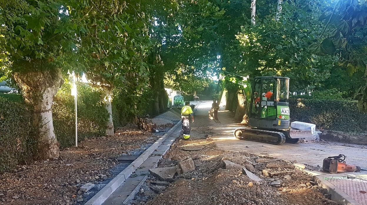 Dos operarios trabajan en la mejora de una de las calles del entorno de las playas. 