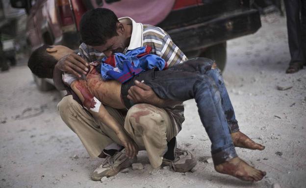 Imagen principal - 1. Un hombre llora el cadáver de su hijo, muerto en un bombardeo en Siria. | 2. El fotógrafo Manu Bravo. | 3. Milicianos rebeldes y civiles celebra el derribo de uno de los cazas de las fuerzas de Gadafi en Bengasi, Libia.