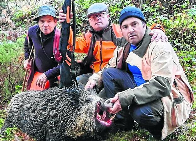 Marcelo Gutiérrez, junto a dos de sus hijos, posa con un jabalí abatido el domingo en La Mahílla, donde cazaba la cuadrilla de Manuel Herrero.