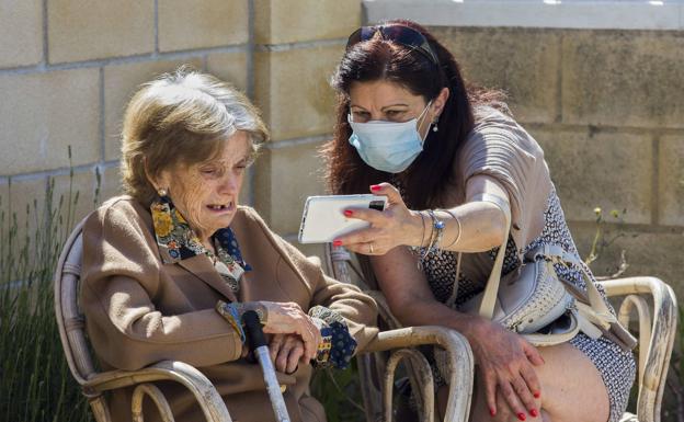 Eloína Ruiz y su madre, María García, mantienen una videollamada, ayer, durante la primera visita en la residencia San Cipriano, en Bezana. 