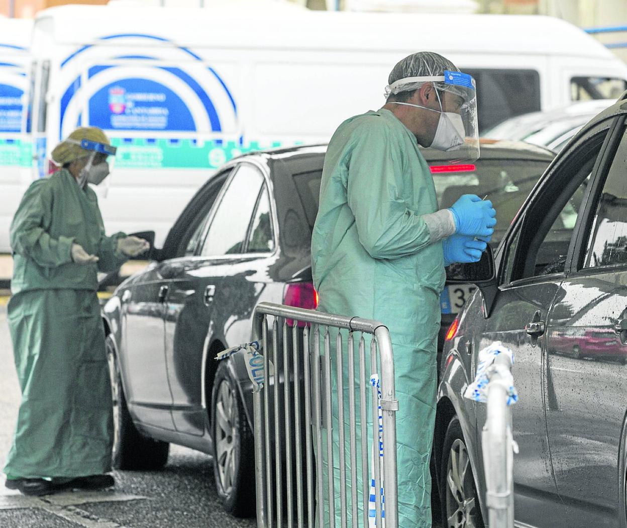 Dos sanitarios toman muestras PCR en el 'coroauto' de Liencres. 