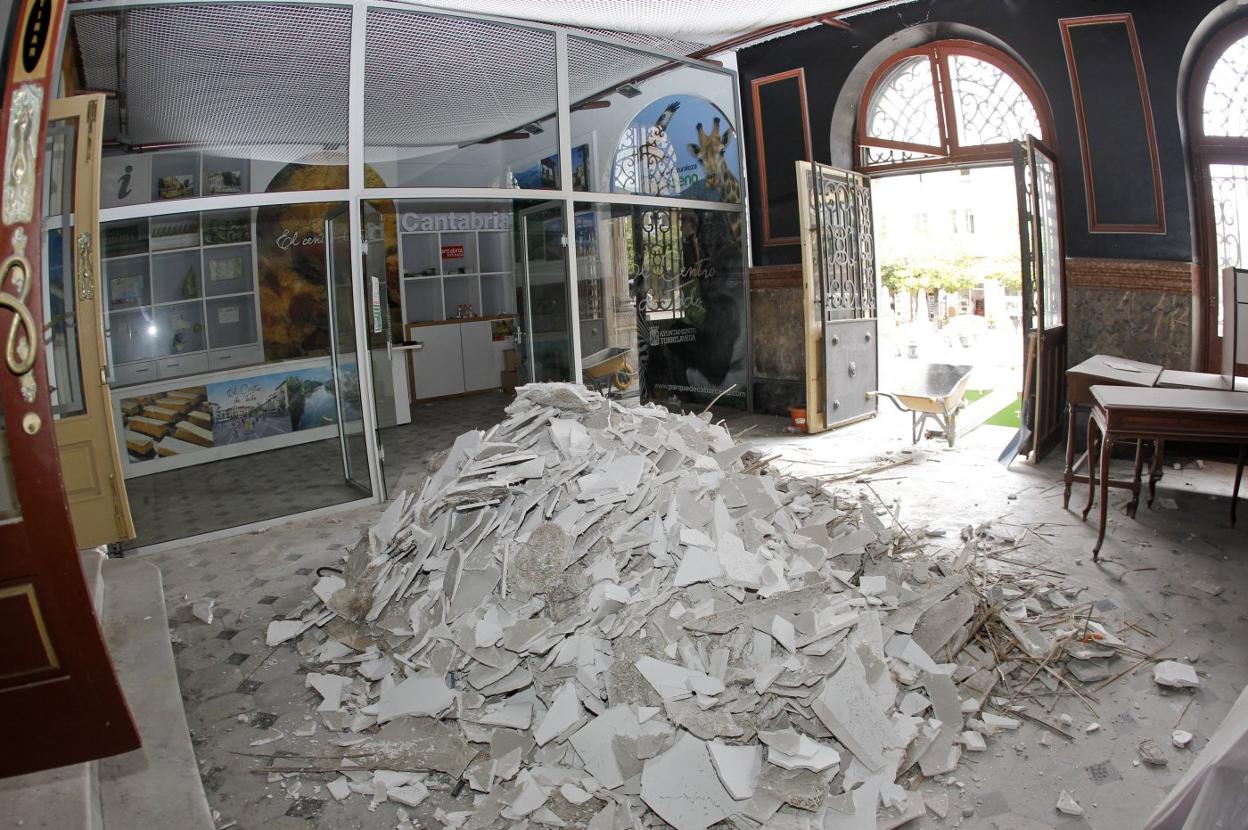 Restos de escayola de los falsos techos retirados hace unos días en el vestíbulo del edificio principal del Palacio municipal.