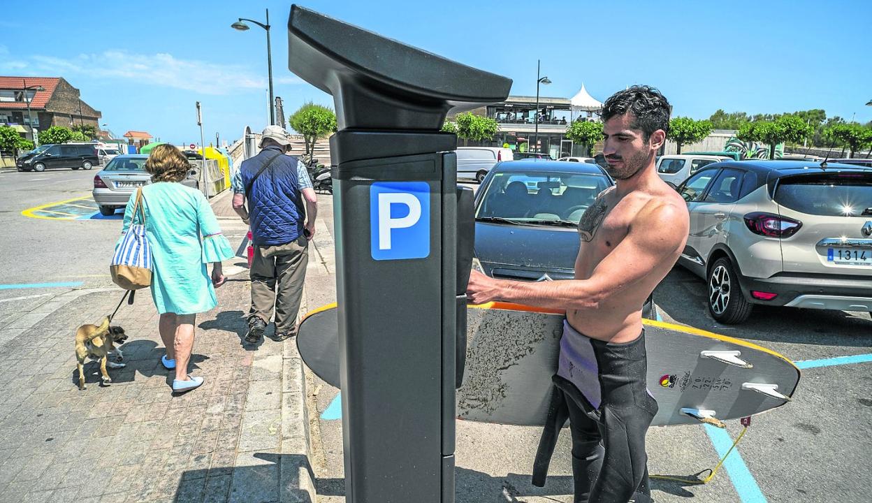 Un turista de Barcelona, tras haber surfeado, expide un segundo tique para alargar el tiempo de estacionamiento. 