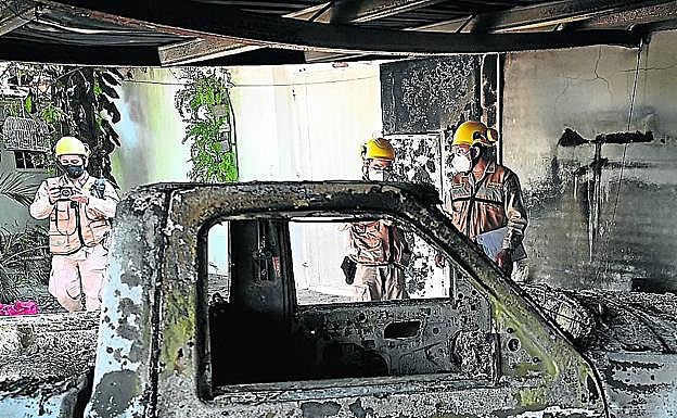 Varios agentes fotografían los restos del vehículo de Scanu..