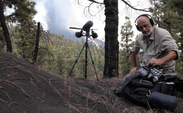 El técnico de sonido y naturalista Carlos de Hita, en un bosque de La Palma, con el humo del volcán al fondo.