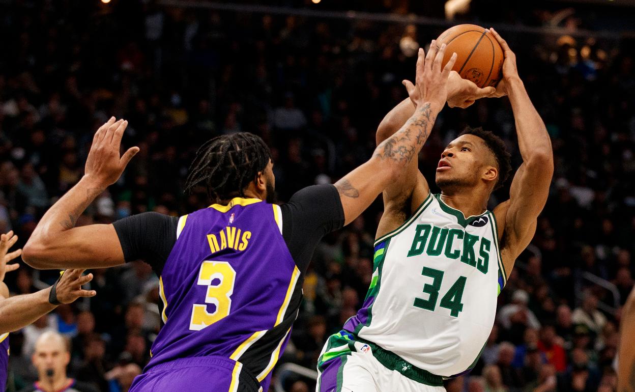 Giannis Antetokounmpo (34) dispara contra el delantero de Los Angeles Lakers Anthony Davis (3).