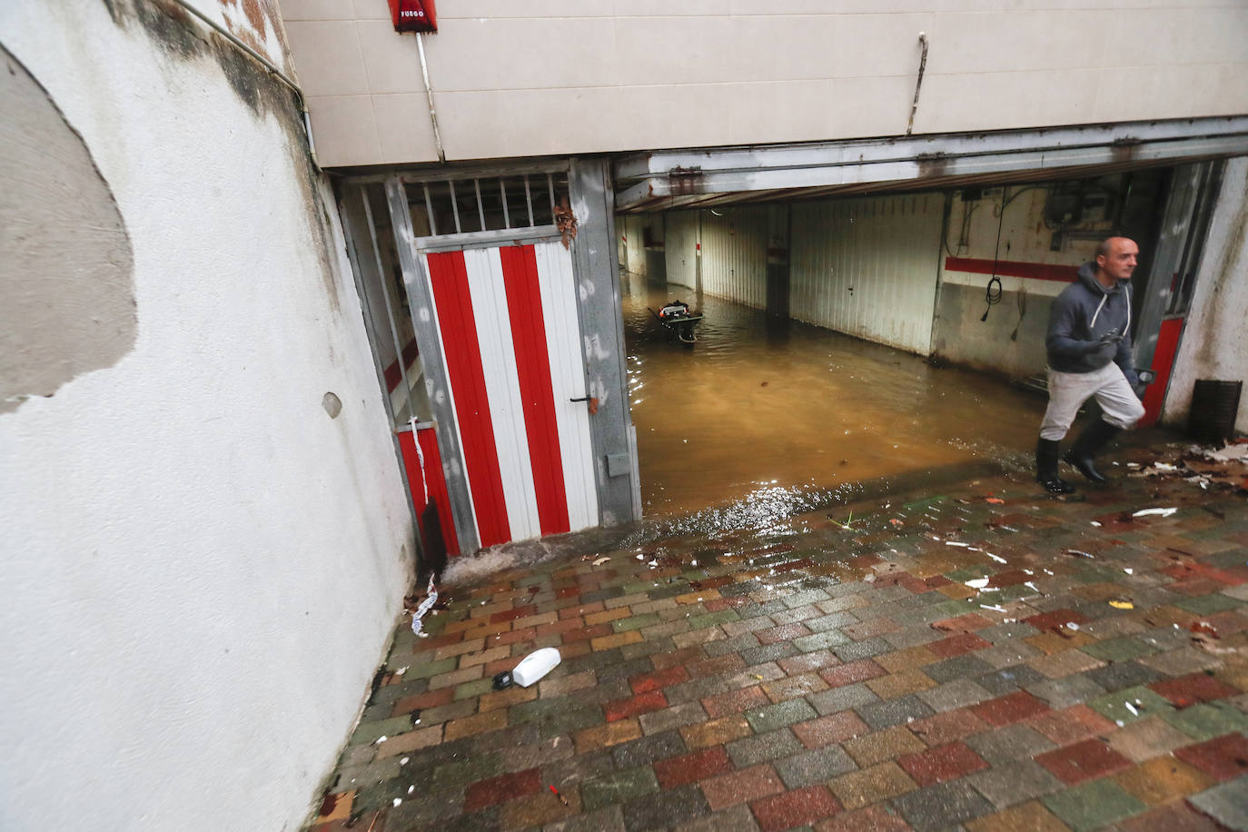 Un vecino sale de su garage inundado en Oruña.