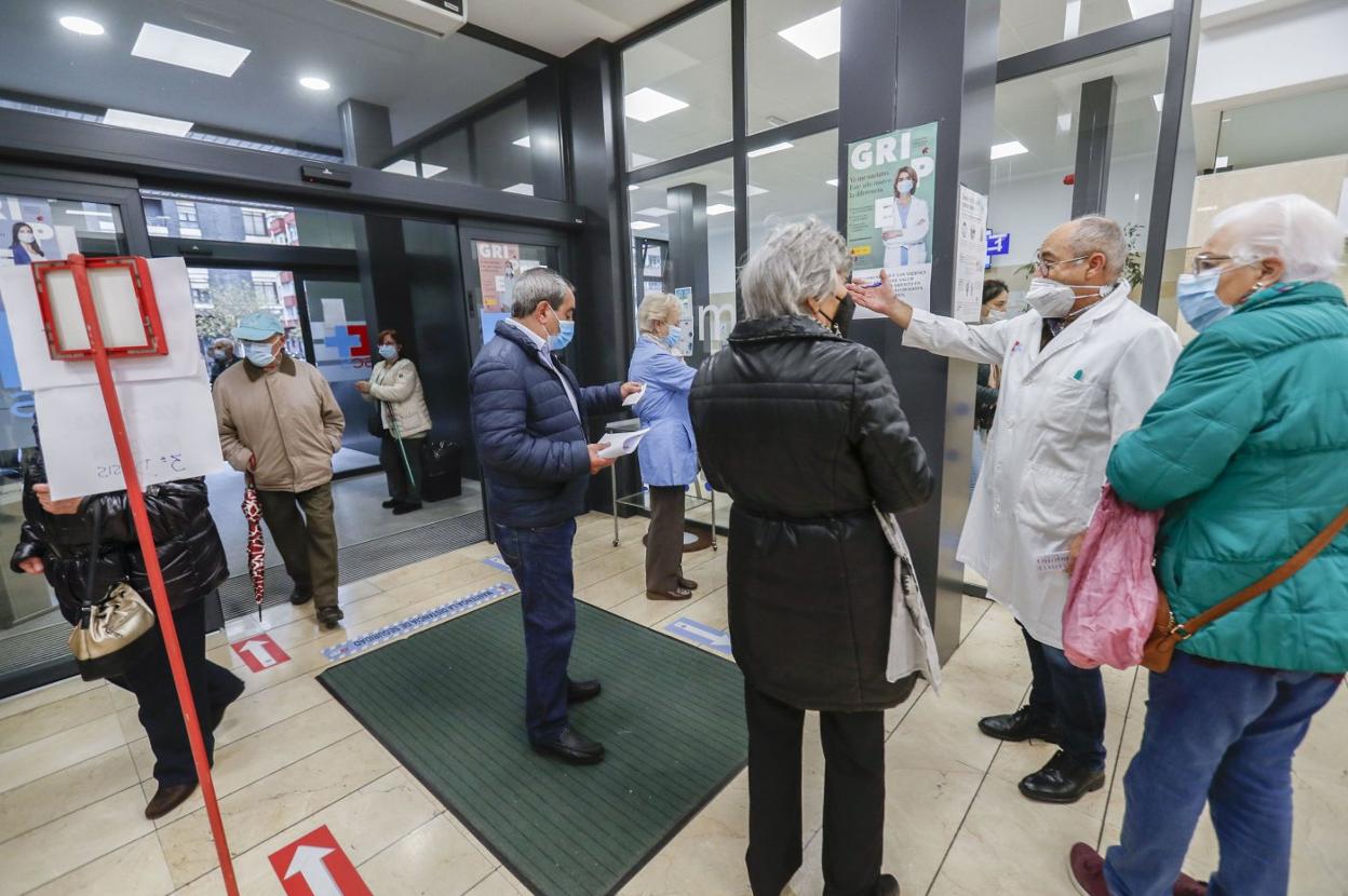 Pacientes a la entrada de un centro de salud de Santander, a la espera de acceder al mostrador de admisión. 