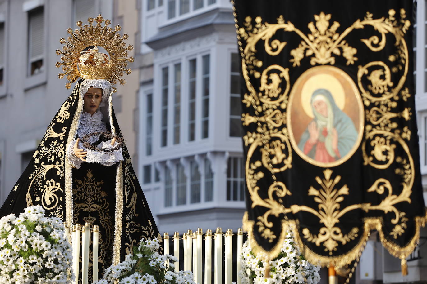 La Virgen Dolorosa vestida de luto sostiene la corona de espinas.