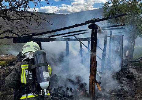 Imagen secundaria 1 - Dos momentos de la extinción del fuego en el cobertizo de San Vitores