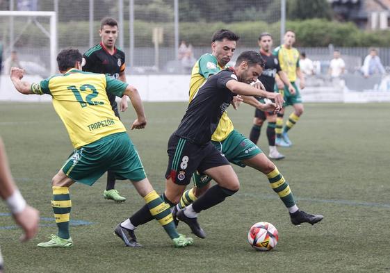 Adri, de la Gimnástica, pelea por el balón con Pelayo, del Tropezón.