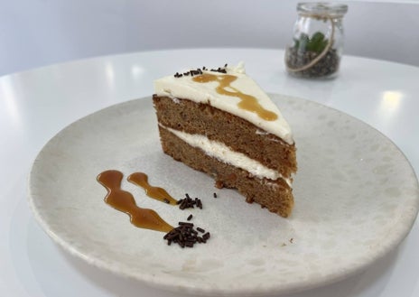 Imagen secundaria 1 - Vista del local distribuido en diferentes alturas, con distintos rincones de lectura. Tarta de zanahoria y limonada de hierbabuena.  
