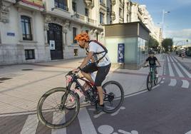 Una familia pasea en bicicleta, a la altura de la rotonda de Puertochico, por uno de los carriles que recorren la ciudad de Santander.