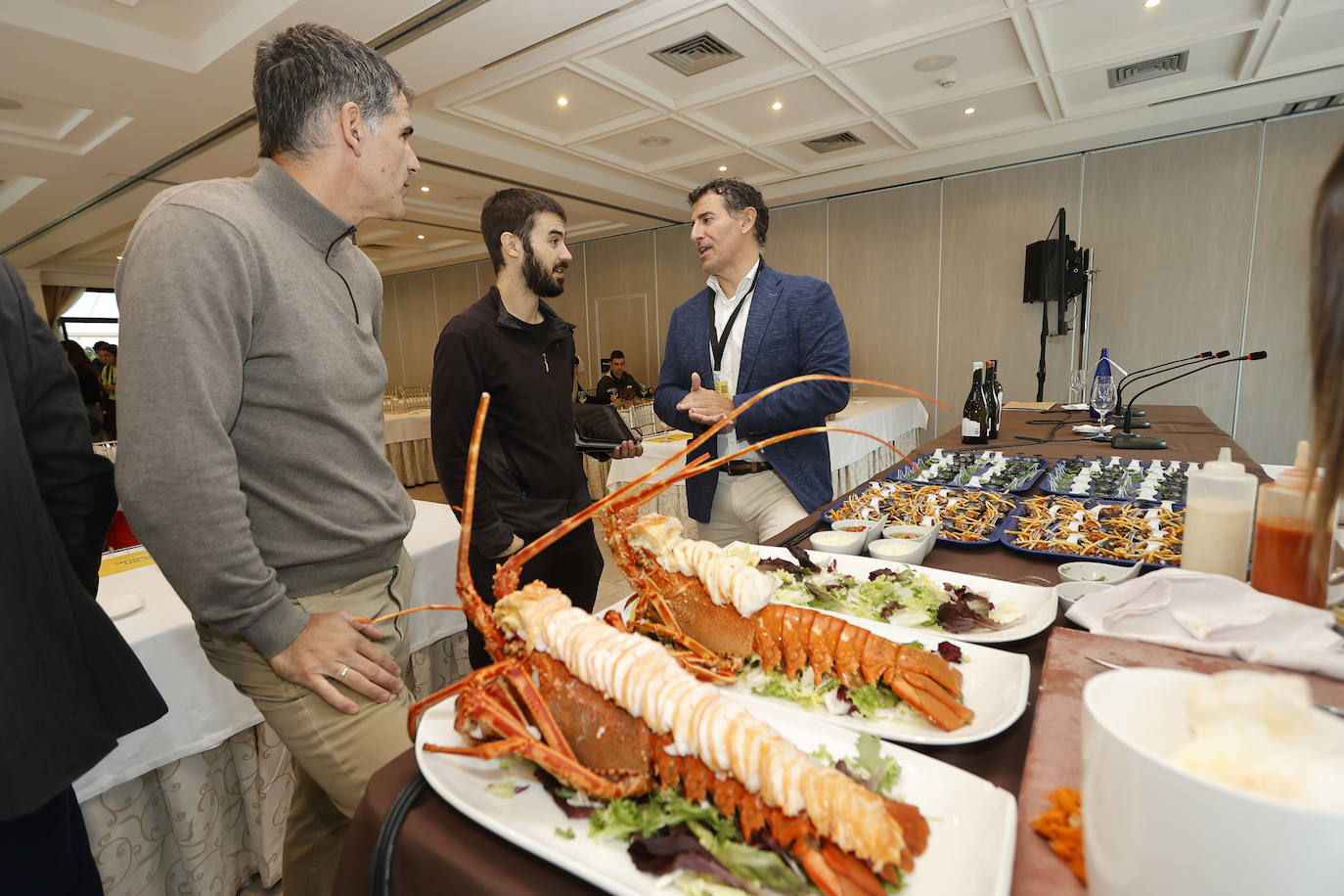 Jorge Cañizo y Emérito Astuy charlan con un asistente a la cata 'Isla, tierra de langosta, pimiento y vino'.