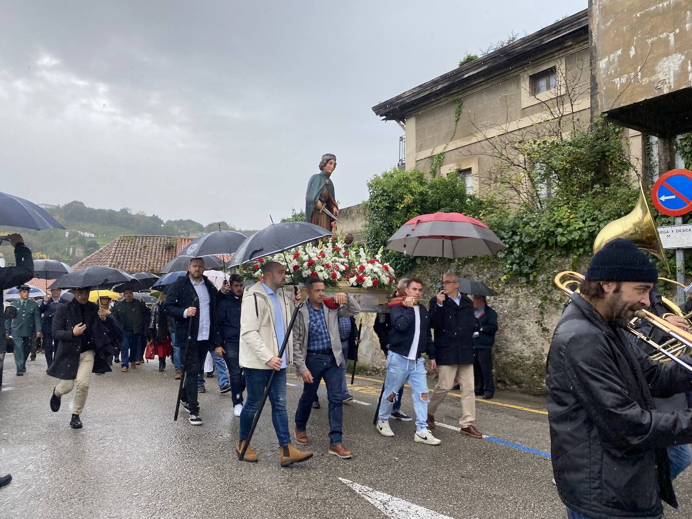 Los paraguas rodearon a San Martín durante la procesión.