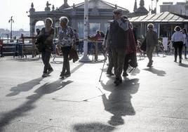 Varios pensionistas pasean por el centro de Santander.