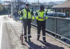 Dos guardias civiles hacen mediciones en el lugar donde se produjo el triple atropello mortal de Suesa.