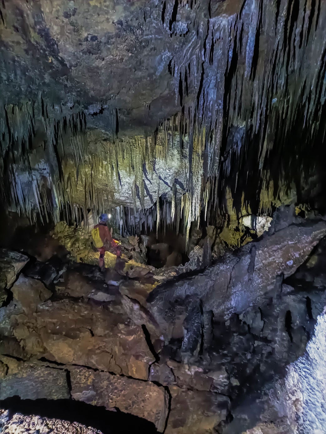 Un espeleólogo observa el desnivel en el interior de la cueva.