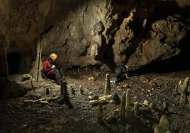 Los miembros de un equipo de investigación documentando la cabaña paleolítica dentro de La Garma