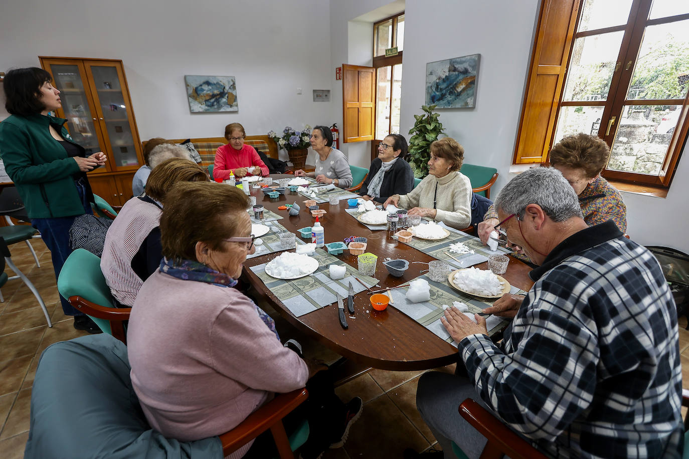 Primeros pasos: Ángela, una de las monitoras del Programa Viernes, explica a las participantes el proceso que van a realizar para crear velas artesanales. El taller se desarrolló en las Antiguas Escuelas de Villasuso de Cieza.